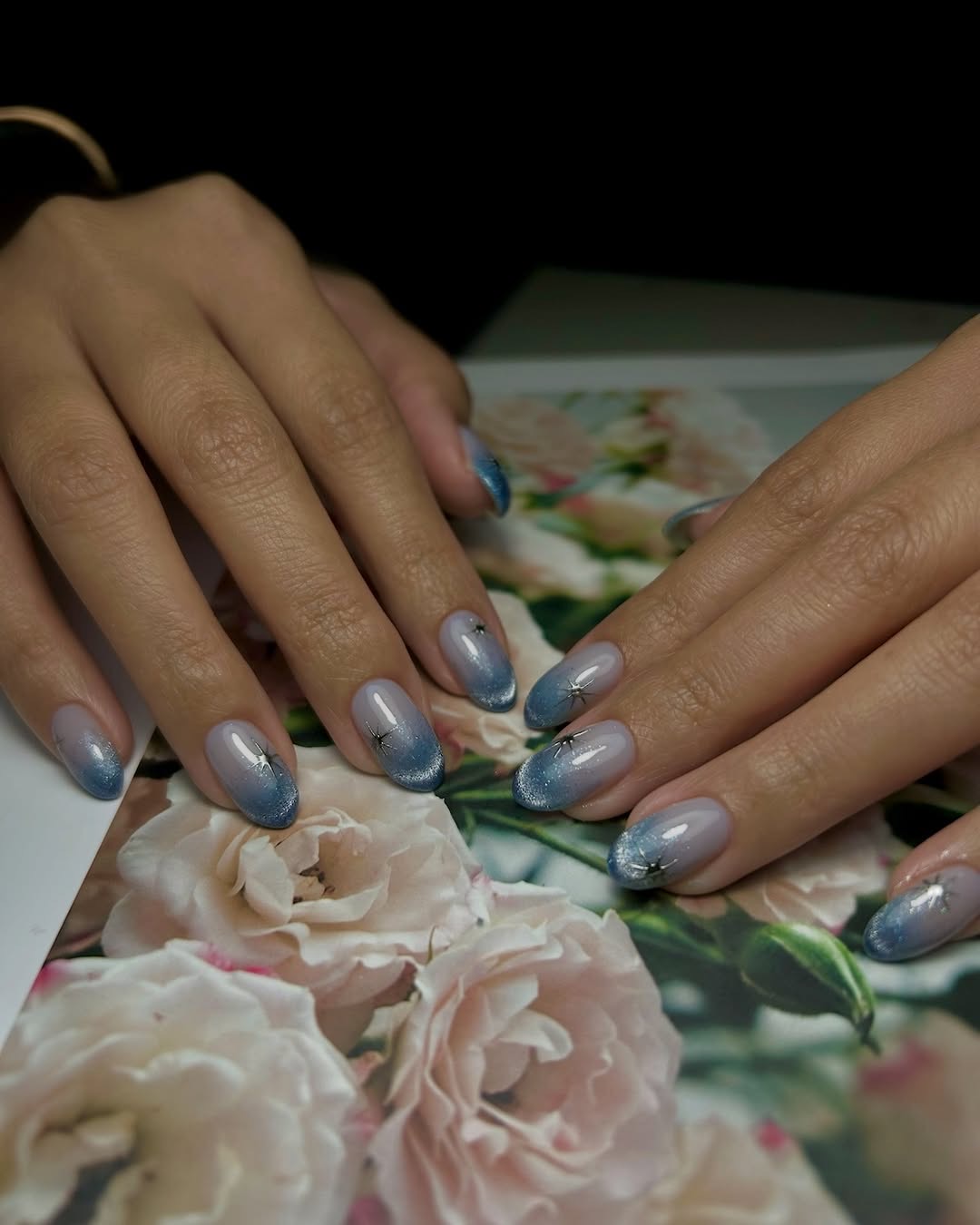 Blue ombre nail art with flowers